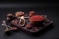 Food, Composition, concept, consisting of several types of different colors of allspice in bowls and spoons on a dark concrete background [IBR124876424]