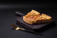 Food, Beautiful delicious quiche pie with four types of cheese with spices and herbs on a dark concrete background [IBR124876427]