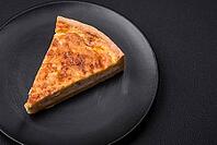 Food, Beautiful delicious quiche pie with four types of cheese with spices and herbs on a dark concrete background [IBR124876431]