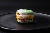 Food, Beautiful tasty macaron with filling and fruit flavor on a black plate on a dark concrete background [IBR124876435]