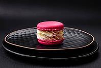 Food, Beautiful tasty macaron with filling and fruit flavor on a black plate on a dark concrete background [IBR124876442]