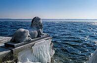 Bavarian lion covered in ice on an icy winter day in Tutzing am Starnberger See, Upper Bavaria, Bavaria, Germany [IBR124898952]