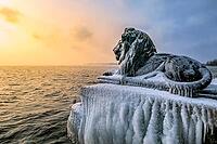 Bavarian lion covered in ice on an icy winter day in Tutzing am Starnberger See, Upper Bavaria, Bavaria, Germany [IBR124898954]