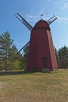 Ancient red wooden windmill with rotor in summer, Loviisa, Finland [IBR124899515]