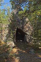 Rock formation of Korsvikin stone church forming a cave in forest in summer, Pernaja, Finland [IBR124899518]