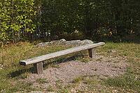 Old weathered wood bench designed for outdoor seating in park on sunny summer day, Loviisa, Finland [IBR124899519]