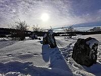 Snowy landscape with sunlit stones, clouds and an extensive field, hiking in winter, Frankenwaldsteigla, 12 Apostle Trail, Frankenwald nature park Park, Upper Franconia [IBR124899545]