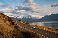 Aerial view of person walking on road on Lake Pukaki with Mount Cook in the background, New Zealand [IBR124899547]