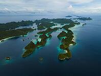 Aerial view of many small tropical islands with turquoise water and exposed reefs, Pulau Wayag, Raja Ampat, West Papua, Indonesia [IBR124899563]