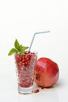 Pomegranate seeds in glass and pomegranate, Punica granatum [IBR124899873]