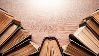 Old books arranged highlighting their historical significance. Neatly arranged representing a collection of wisdom, AI generated [IBR124899889]