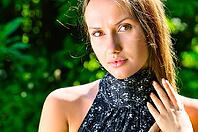 Sexy young woman in trees at sunny weather [IBR124906353]