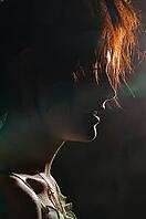 Silhouette at night of a young ginger woman [IBR124906385]