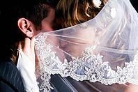 Just married couple is kissing under veil [IBR124906386]
