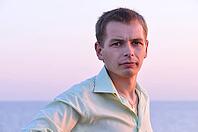 Serious adult man at sunrise near the sea [IBR124906388]