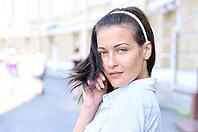 Sensual woman is looking back at sunny street [IBR124906392]