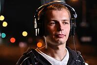 Man listening music at city night street [IBR124906394]