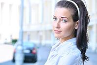 Closeup portrait of a woman at sunny street [IBR124906397]