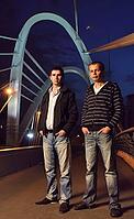 Two guys standing on the night bridge and looking at camera [IBR124906405]
