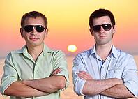 Two friends at sunset wearing sunglasses fold their arms [IBR124906407]