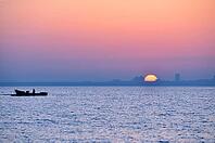 City silhouette from sea at sunrise [IBR124906417]
