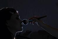 Woman is applying makeup in dark [IBR124906427]