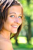 Smiling woman at summer park [IBR124906428]