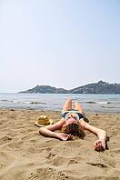 Sexy woman is lying on the beach [IBR124906432]