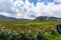 View of the Scottish Highlands, green meadows and cloudy skies in summer 2018 [IBR124915223]