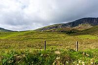 View of the Scottish Highlands, green meadows and cloudy skies in summer 2018 [IBR124915242]
