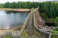 View from the lakeshore near the dam wall against a cloudy sky, near Aberchalda in summer 2018 [IBR124915248]
