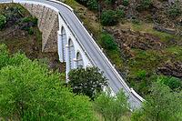 View from above of a valley with a bridge over a river in Mertola in spring 2019 [IBR124915274]