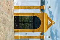 View of a black gate with a yellow border in a white wall in Mertola in spring 2019 [IBR124915275]
