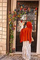 Traveling woman captures images while exploring charming old town architecture and culture [IBR124920192]