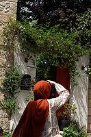 Traveling woman captures images while exploring charming old town architecture and culture [IBR124920200]