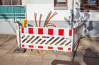 Construction site for laying fiber optic cables in front of a residential building, Bremen, Germany [IBR124920246]