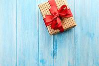Christmas or New Year decorated gift box on blue wooden background [IBR124944045]