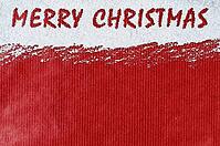 Merry christmas handwritten on snow and red craft paper [IBR124944053]