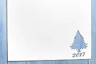 Cut paper in christmas tree shape for christmas card or new year background on wooden table [IBR124944055]
