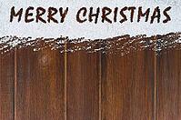 Merry christmas handwritten on snow and wooden table [IBR124944057]