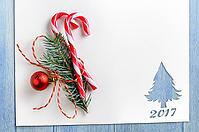 Cut paper in fir-tree shape with decoration for christmas card or new year background on blue table [IBR124944064]
