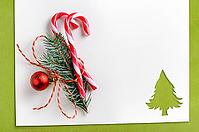 Cut paper in fir-tree shape with decoration for christmas card or new year background on green table [IBR124944065]