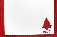 Cut paper in fir-tree shape for christmas card or new year background on red table [IBR124944068]