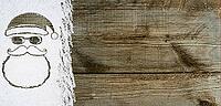 Christmas card or new year background made of santa claus symbol handwritten on snow and wooden table [IBR124944090]