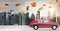 Food delivery. Autumn red toy car with fallen leaves delivering fruits and vegetables against business district buildings [IBR124944117]