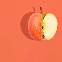 Fresh apple on pink background, view from above [IBR124944129]
