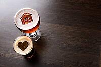 Loving local craft beer. House and heart silhouettes in two glasses of fresh beer on pub table, view from above [IBR124944132]
