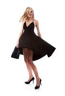 Portrait of beautiful blonde model poses in black dress [IBR124968407]