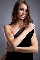 Attractive young model covers her chest with black cloth [IBR124968418]