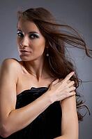 Attractive young model covers her chest with black cloth [IBR124968459]